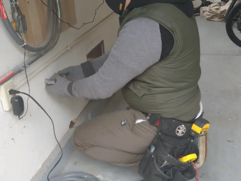 Electrician performing outlet wiring in a Suncrest garage